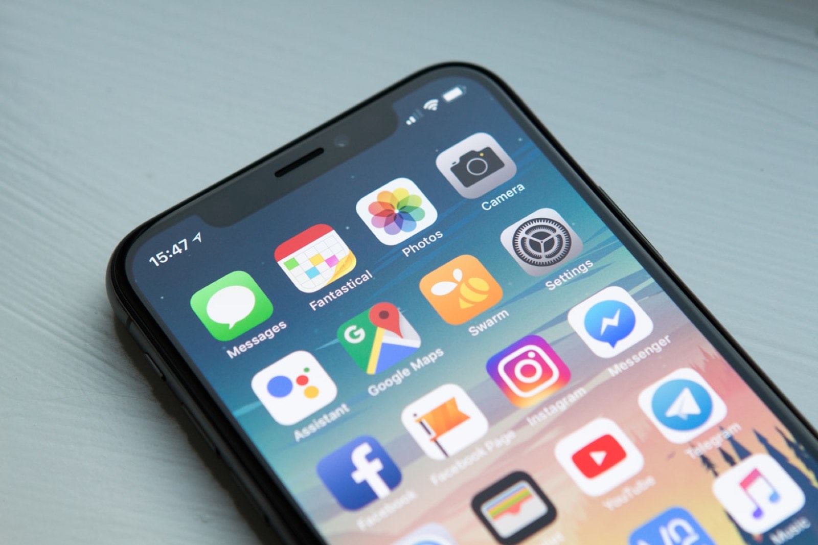 A smartphone home screen with a grid of apps.