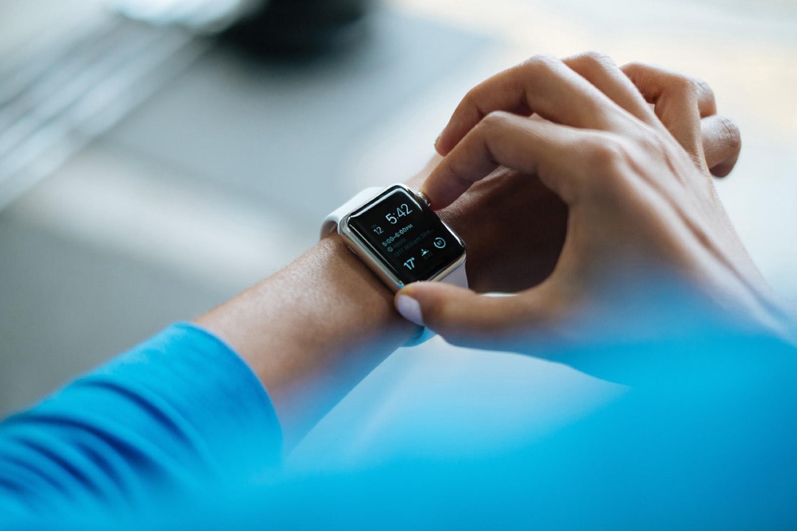 A person checking a schedule on a smartwatch.