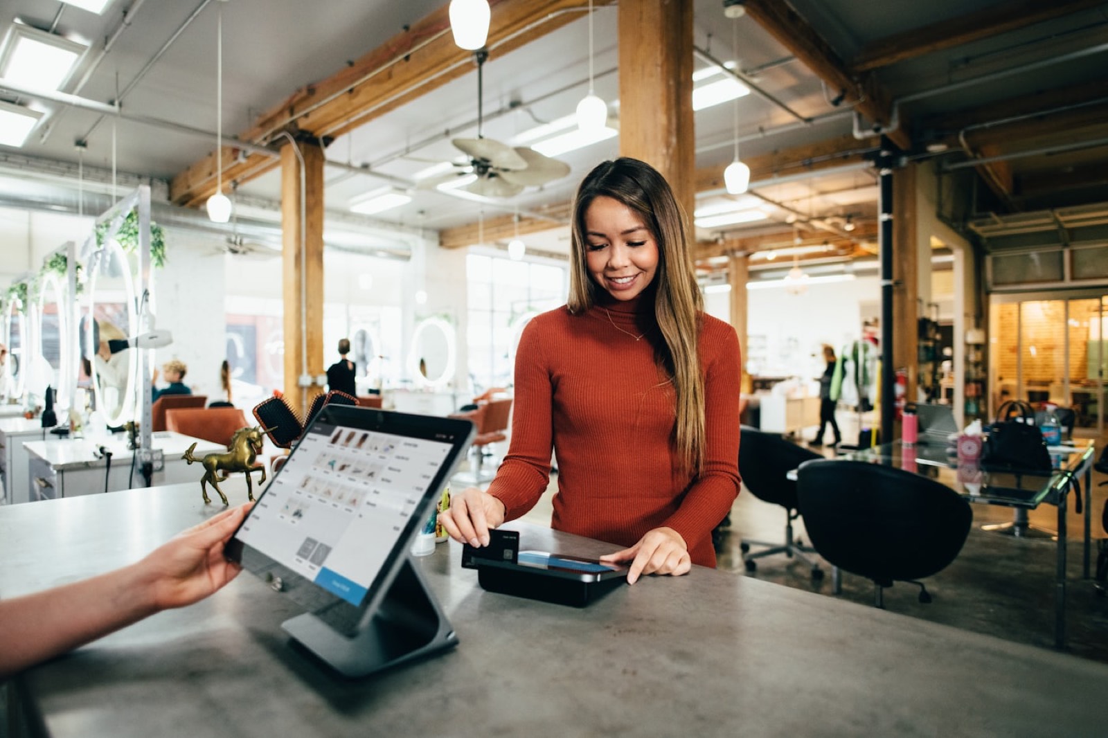 A customer paying at a small-business counter.