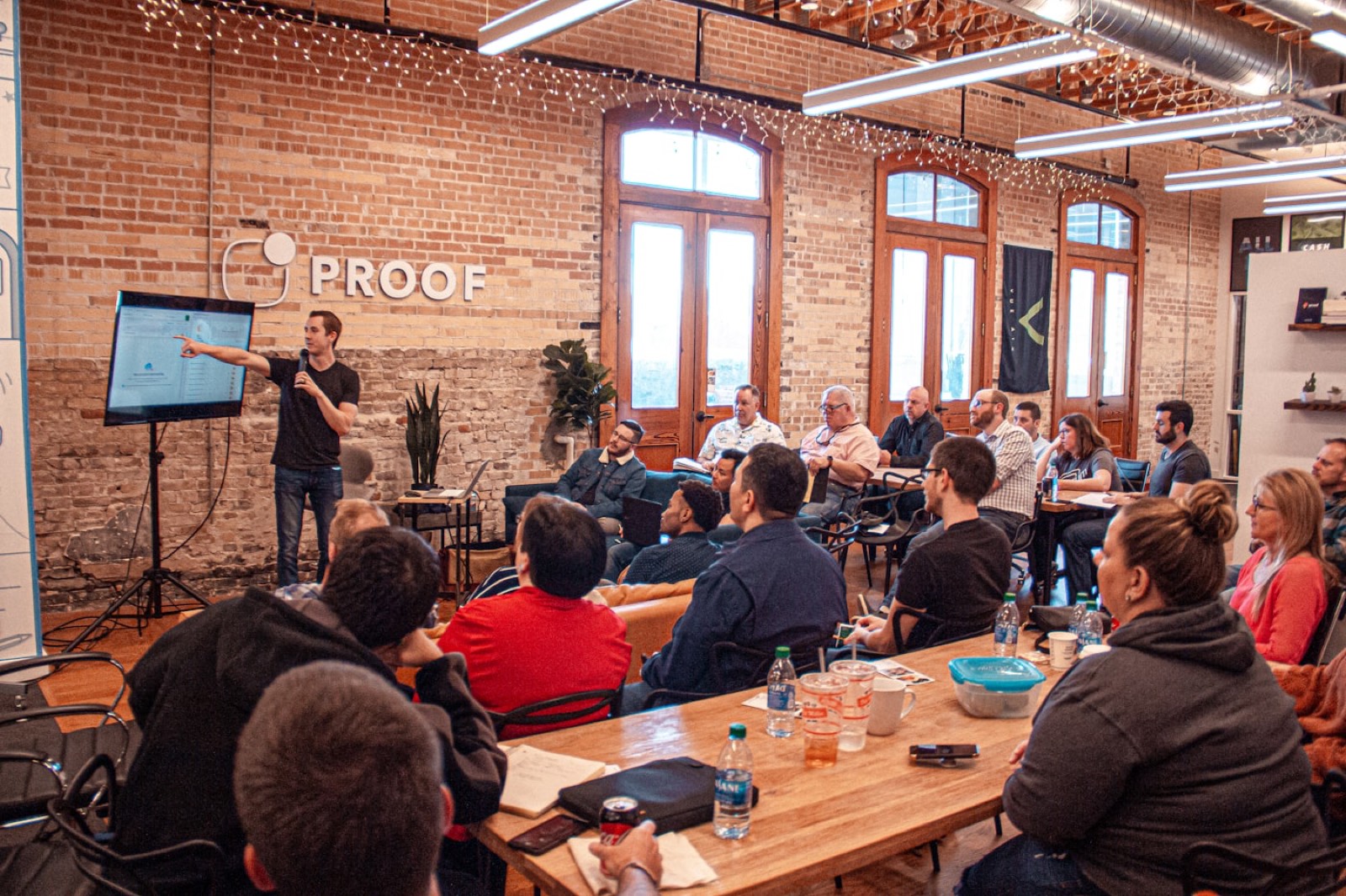 A presenter showing a screen to people seated in a workshop.