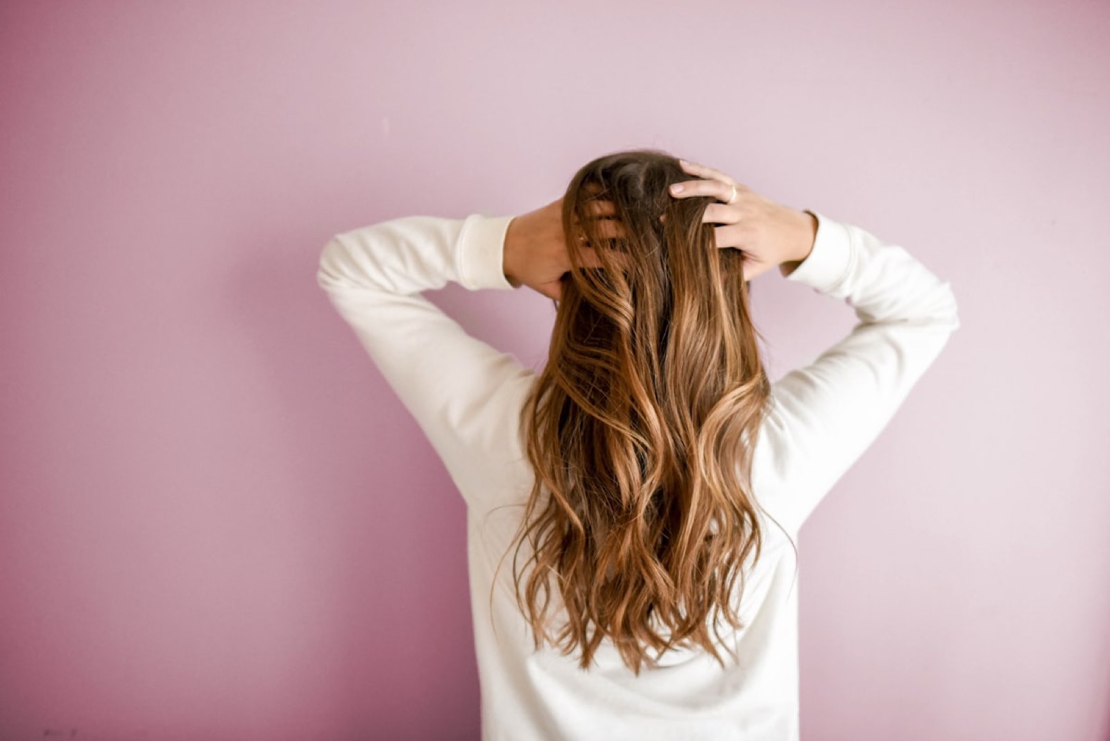 A stylist standing in a salon, ready for the next client.